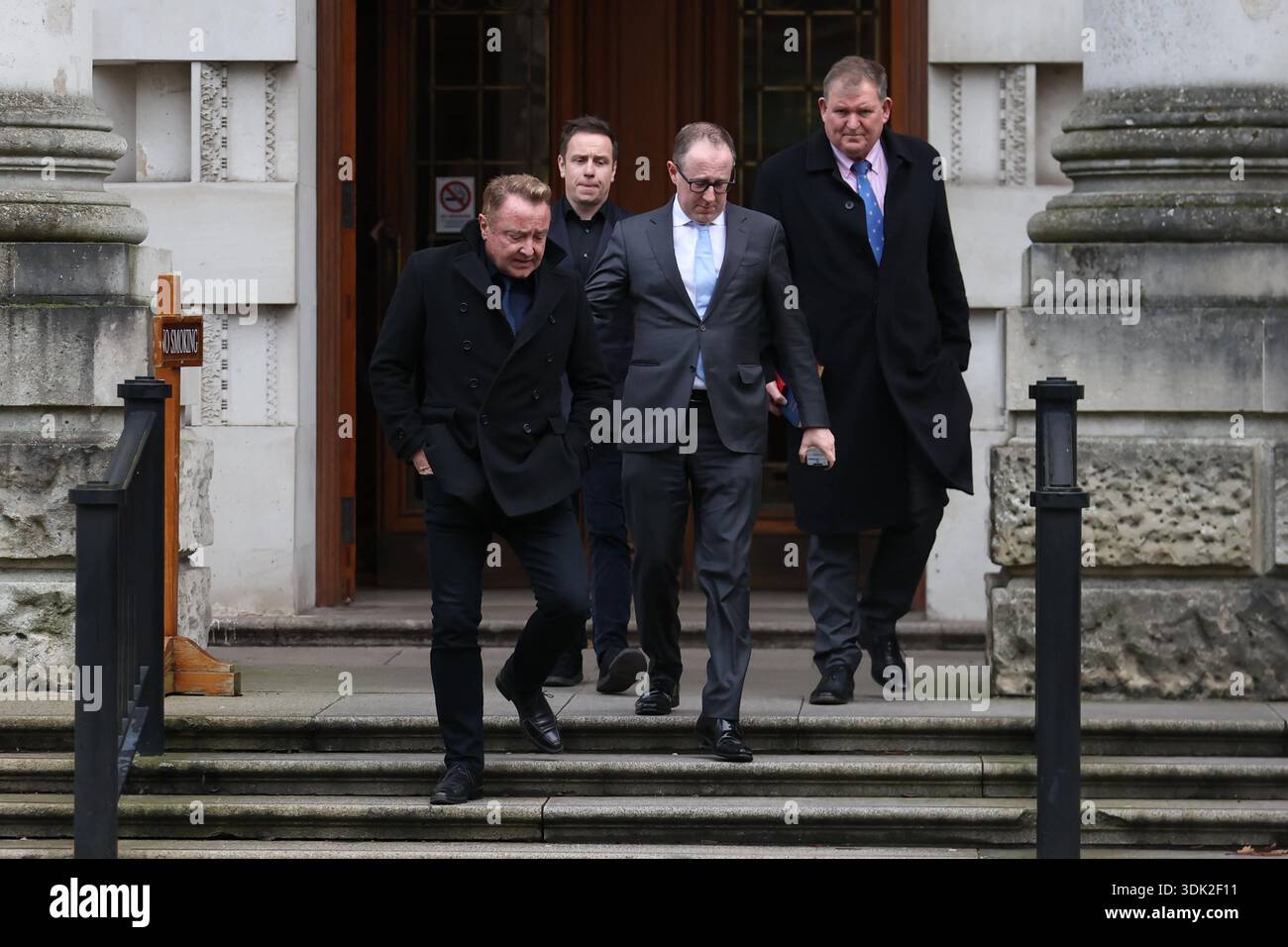 Michael Flatley (left) leaving Belfast High Court, after a legal order blocking him from engaging with the Lord of the Dance production has been overturned. At The Chancery Court in the Royal Courts of Justice on Thursday, Mr Justice Simpson discharged a temporary injunction that had been secured against the dancer and choreographer. Picture date: Thursday January 29, 2026. Foto Stock