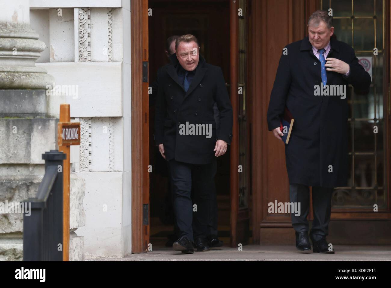Michael Flatley (left) leaving Belfast High Court, after a legal order blocking him from engaging with the Lord of the Dance production has been overturned. At The Chancery Court in the Royal Courts of Justice on Thursday, Mr Justice Simpson discharged a temporary injunction that had been secured against the dancer and choreographer. Picture date: Thursday January 29, 2026. Foto Stock