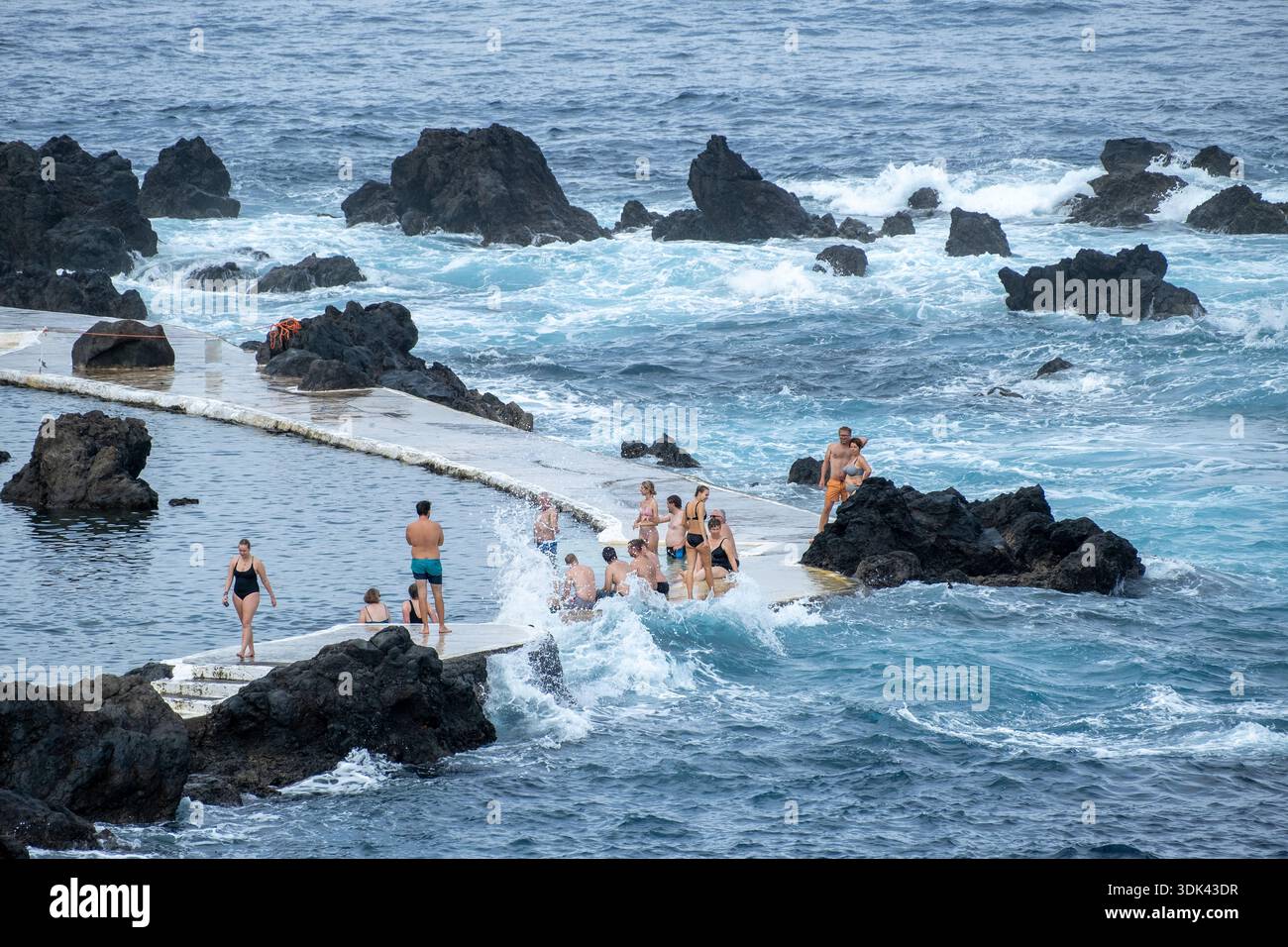 Persone che fanno il bagno in piscine naturali di lava vulcanica, Porto Moniz, isola di Madeira, Portogallo, Oceano Atlantico, Europa Foto Stock