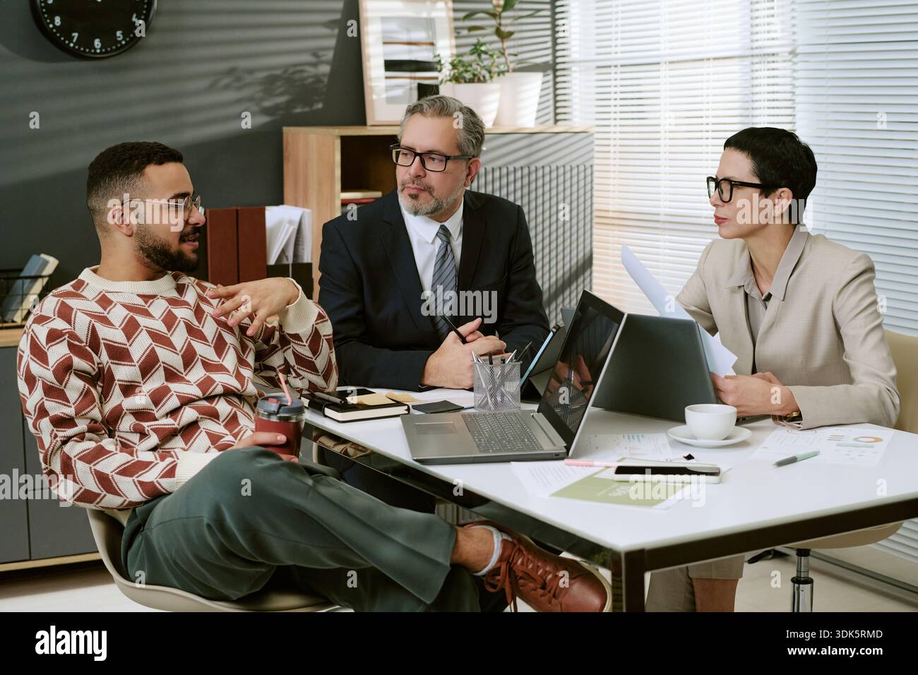 Team multietnico di business che discute della strategia di progetto durante la riunione dell'ufficio Foto Stock