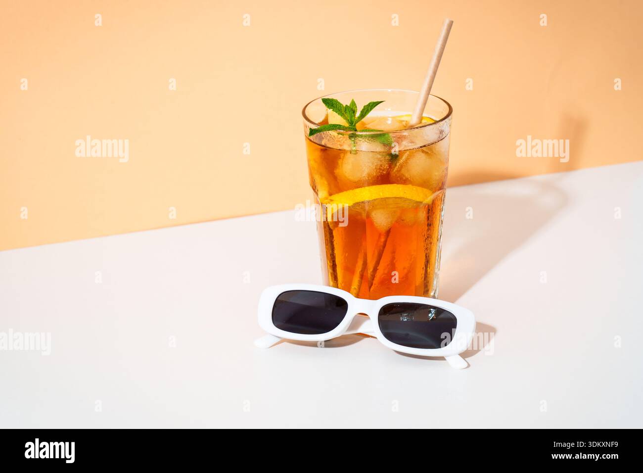 Drink freddo estivo, cocktail ghiacciato lungo isola con occhiali da sole e ombre assolate. Foto Stock