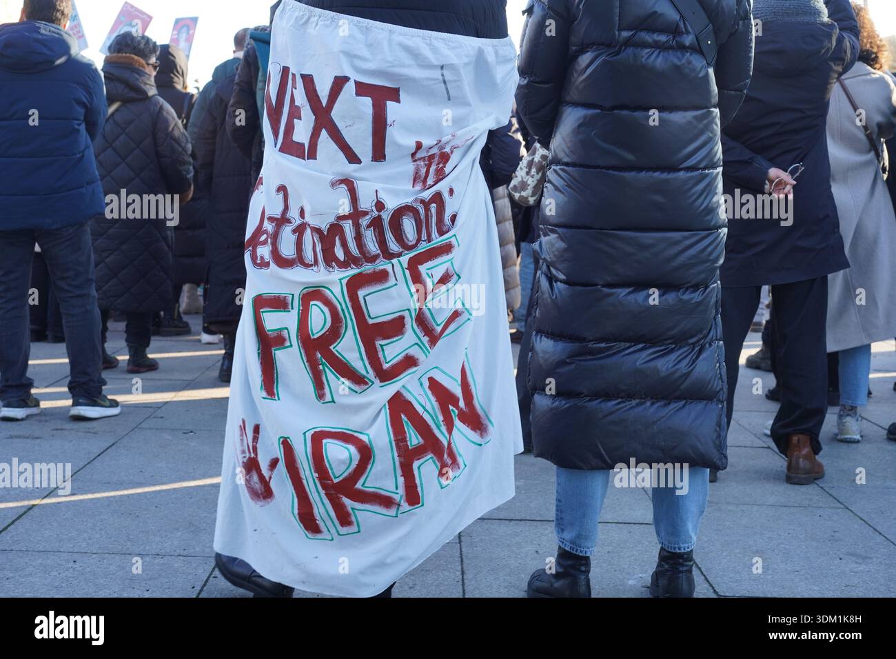 Berlino, Germania - 18 gennaio 2026: Manifestante con la bandiera "Iran libero" alla manifestazione Echo Iran contro il regime a Washingtonplatz, Berlino Foto Stock