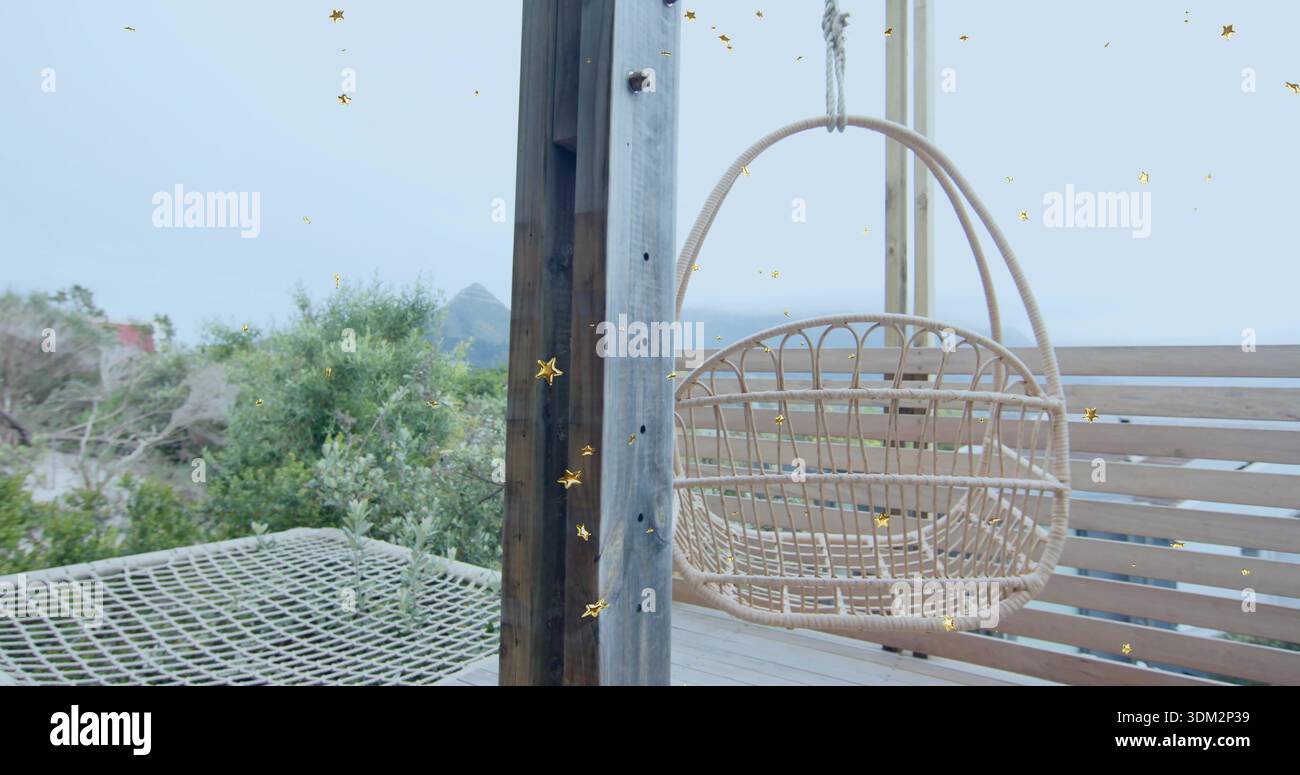 Sedia a uovo in rattan ondulata appesa al fascio sospeso sul ponte fronte spiaggia, con amaca a rete Foto Stock