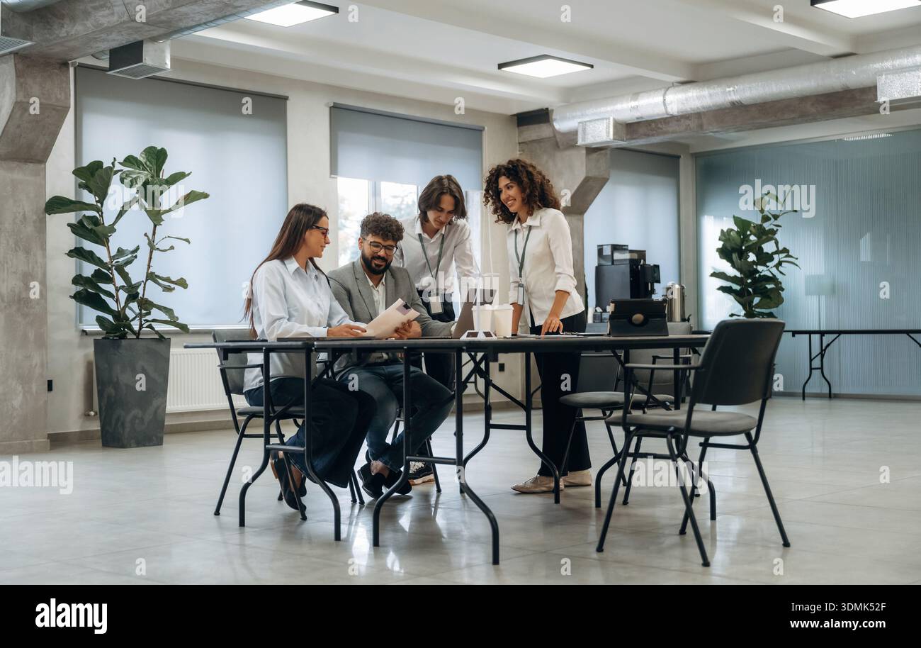 Tavolo con laptop. Un gruppo di persone lavora in ufficio insieme come un team. Foto Stock