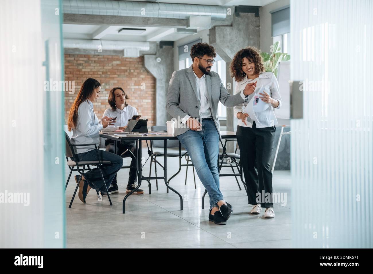 Appoggiato sul tavolo. Un gruppo di persone lavora in ufficio insieme come un team. Foto Stock