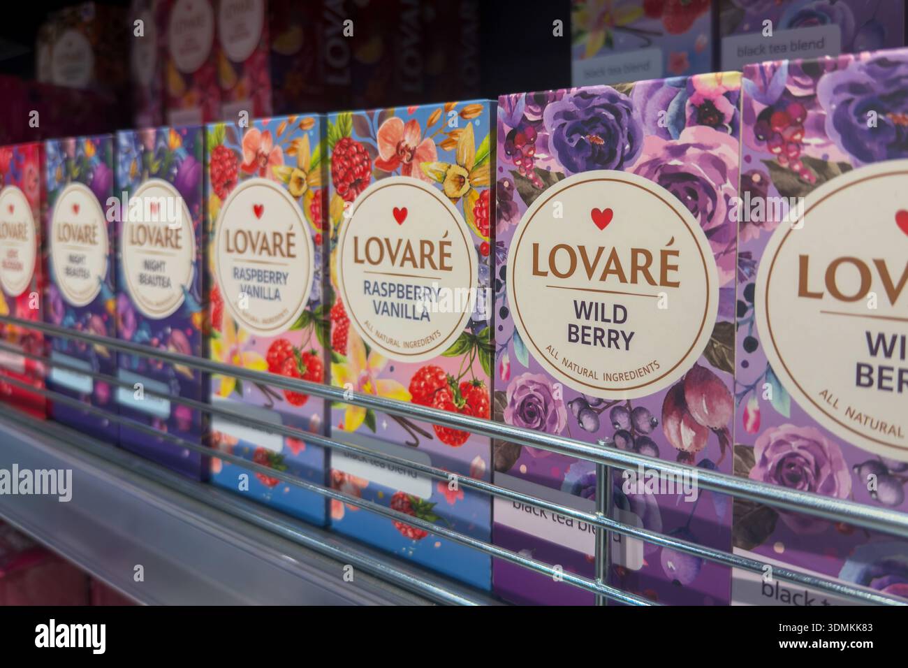 Poznan, Polonia - 22 novembre 2025: Una prospettiva a livello di occhi dello scaffale del supermercato con varie scatole da tè colorate, che offrono varietà di varietà naturali e fruttate Foto Stock