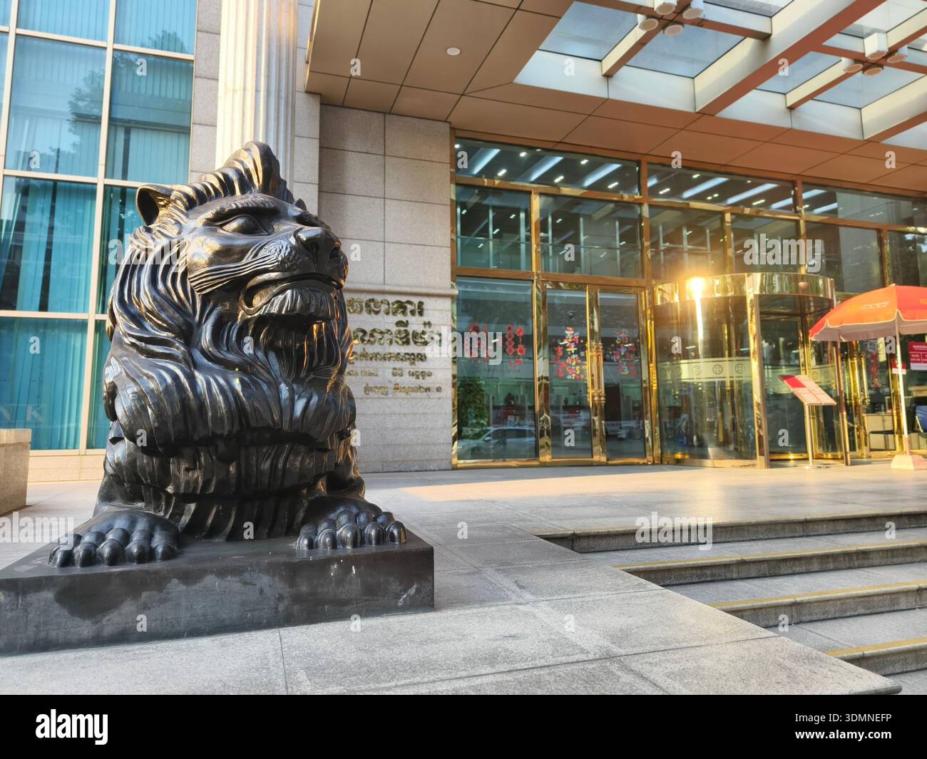 Ingresso alla torre Canadia, Phnom Penh, Cambogia. le statue dei leoni fungono da guardiani tradizionali che simboleggiano protezione, forza, potere e prosperità. Foto Stock