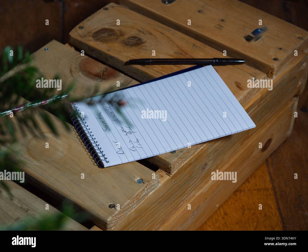 Lettera a Babbo Natale sulla vista del blocco note attraverso l'albero di Natale Foto Stock