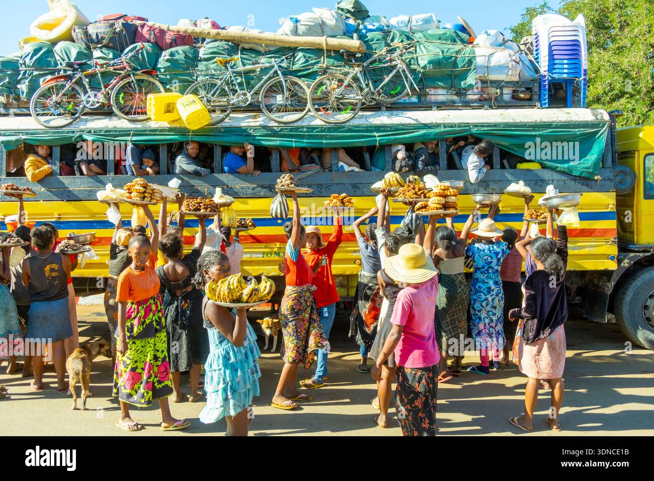 Madagascar, regione Atsimo-Andrefana, Andranovory, città all'incrocio tra la National Route 7 e 10, RN7 e RN10, taxi condiviso (autobus) assalito da venditori di cibo Foto Stock