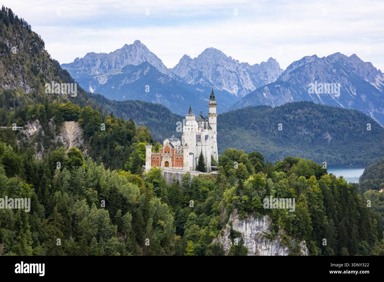 Vista aerea del castello di Neuschwanstein, una visione fiabesca di pietra bianca e mattoni rossi tra foreste di smeraldo sotto picchi frastagliati, Neuschwanstein CASL Foto Stock