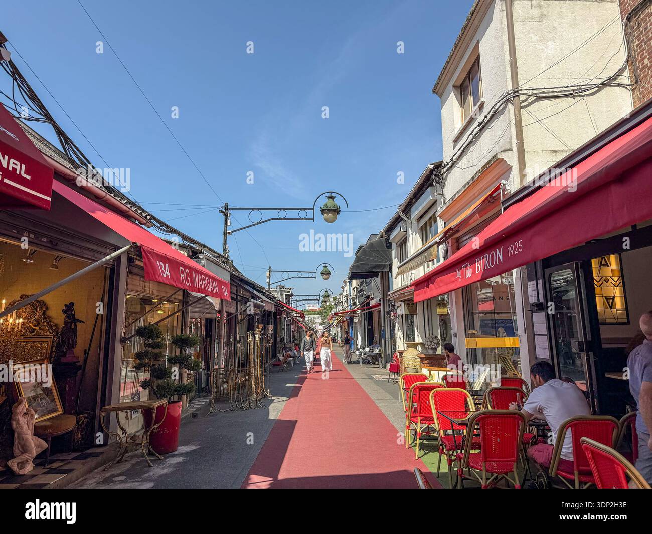 PARIGI, FRANCIA - 22 GIUGNO 2025: Le persone passeggiano nelle Marche Biron, Puces de Saint-Ouen, vicino a Parigi, Francia. Negozi d'antiquariato, oggetti d'epoca, posti a sedere in caffetteria Foto Stock