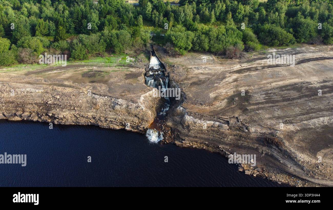 Colpo d'acqua ad alto angolo che precipita nel Baitings Reservoir su un paesaggio roccioso e arroccato durante una grave siccità Foto Stock