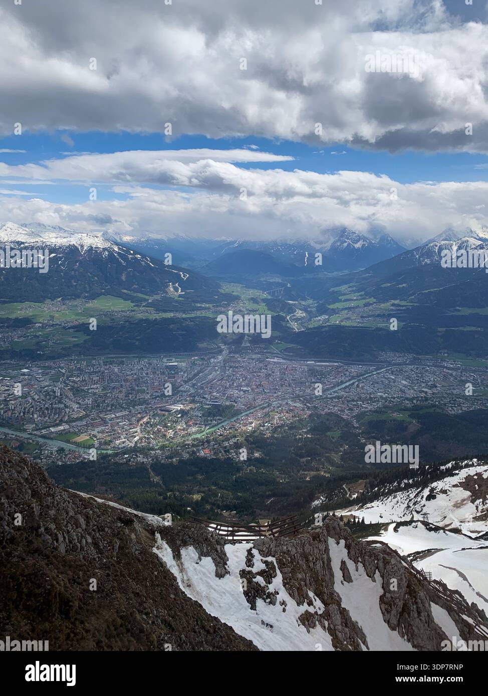 Vista su Innsbruck e sul fiume Inn dalle montagne ad aprile. Vista panoramica dalla cima della Nordkette a Innsbruck e alla catena montuosa, Tirol, Austria. - Immagine stock catturata con smartphone