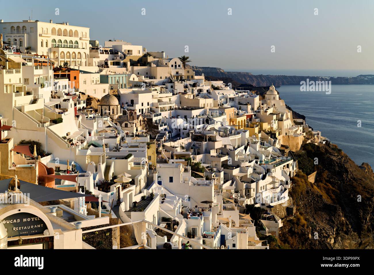 Fira, Santorini, Grecia: Edifici e hotel di colore bianco si aggrappano alla scogliera della caldera, offrendo ai turisti e al resid splendide vedute del Mar Egeo Foto Stock