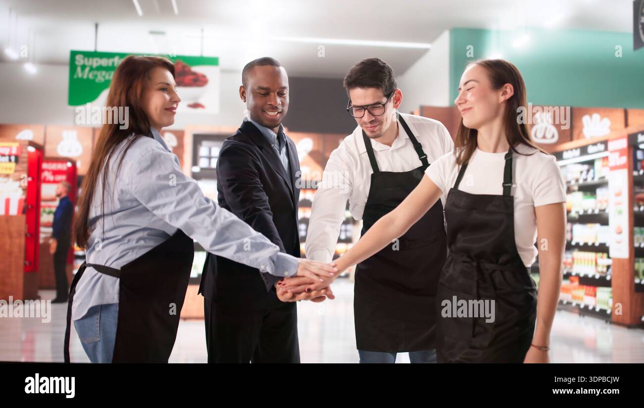 Collaborazione tra team: Gruppo diversificato che gestisce insieme il negozio di alimentari Foto Stock