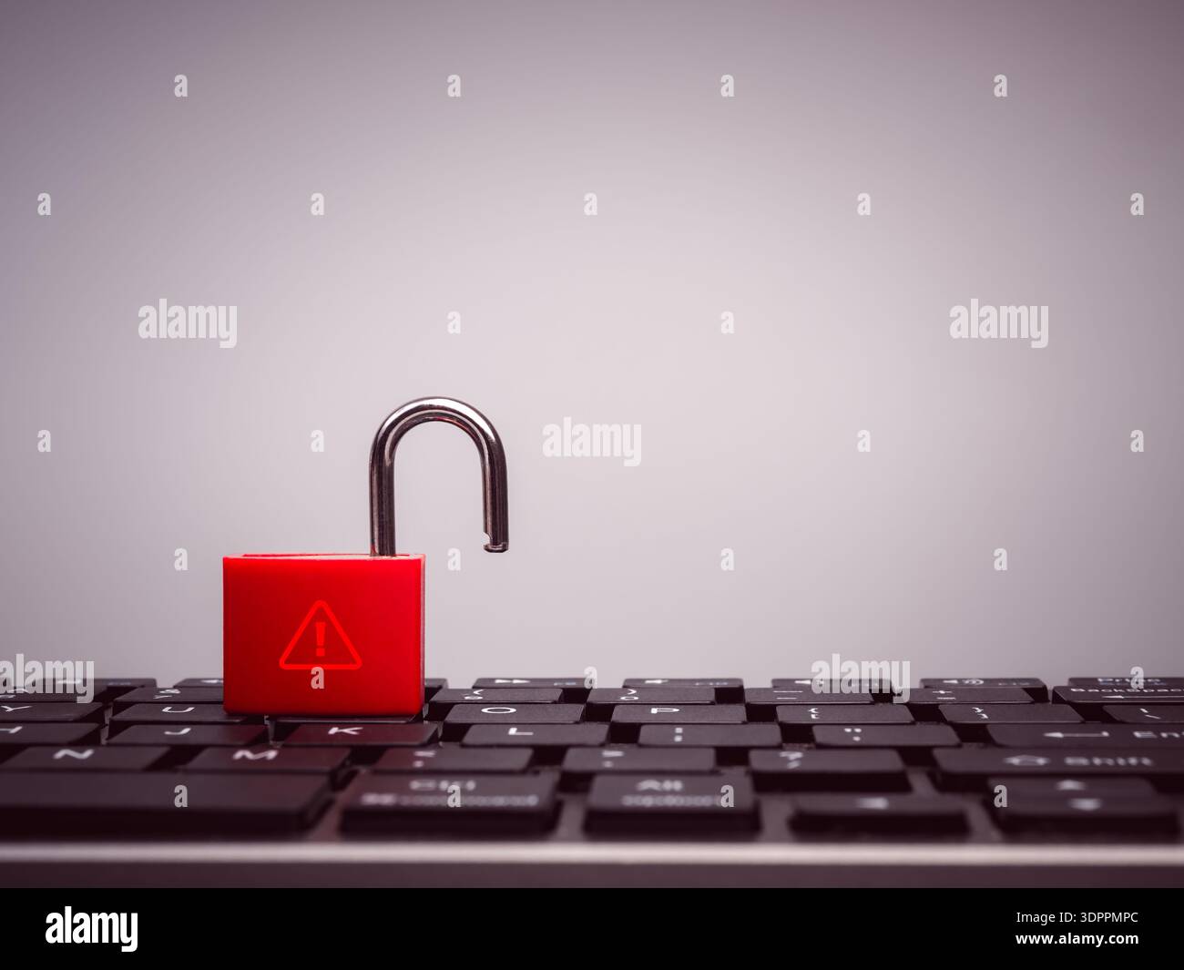 Concetto di sicurezza informatica con lucchetto rosso sbloccato con icona di avviso sulla tastiera nera del computer. Simboleggia la violazione dei dati, la vulnerabilità della sicurezza, ha Foto Stock