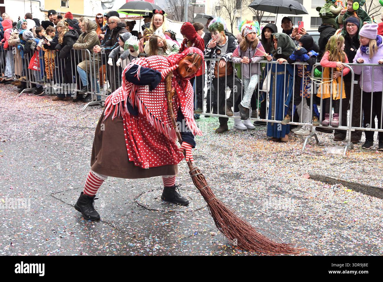 14 febbraio 2026, Coira, Graubünden, Svizzera, Carnevale a Coira il 14 febbraio 2026. Figura strega con scopa davanti agli spettatori, coriandoli su Foto Stock