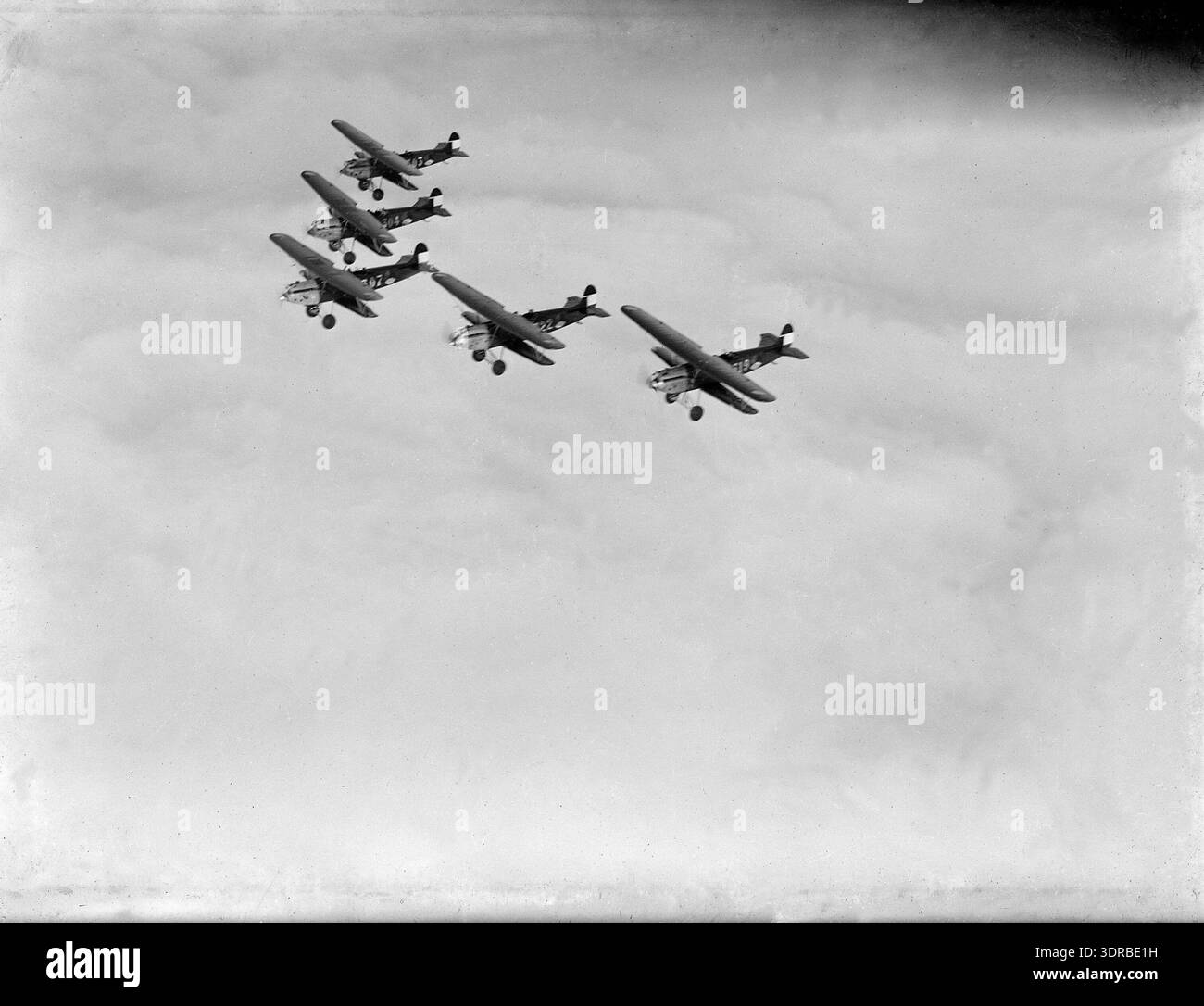 Gli aerei da caccia biplani della Dutch Air Force con propulsione ad elica volano in formazione sopra l'area circostante la base aerea di Soesterberg, Paesi Bassi. Questi biplani monomotore, utilizzati tra il 1927 e il 1933, dimostrano tattiche aeree coordinate. La fotografia cattura le ali degli aerei, le eliche, il volo di formazione, l'altitudine e i primi metodi di aviazione militare, evidenziando l'ambiente operativo e la tecnologia degli aerei da combattimento aerei olandesi tra le due guerre. Foto Stock