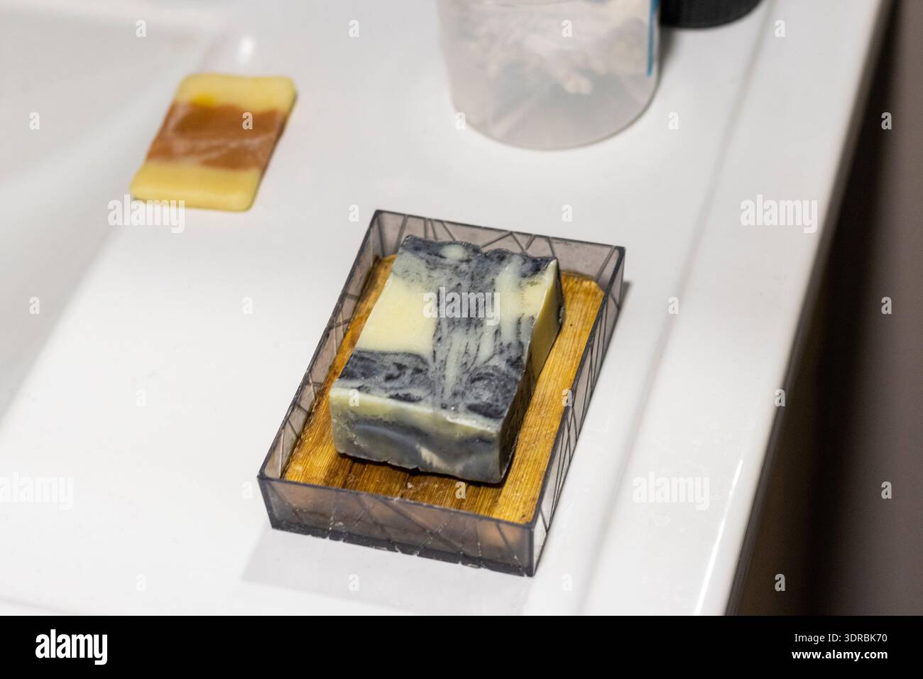Il sapone цшер la saponetta realizzata a mano contiene carbone attivo, olio di neem, olio di canapa e burro di karité. Foto Stock