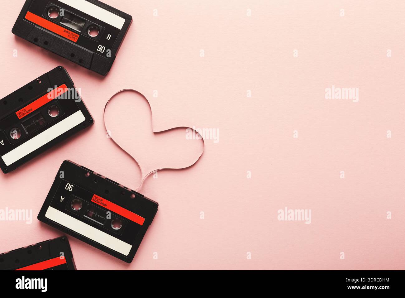 Collage cassette con forma a cuore su sfondo rosa con musica ed elementi Nostalgia Foto Stock