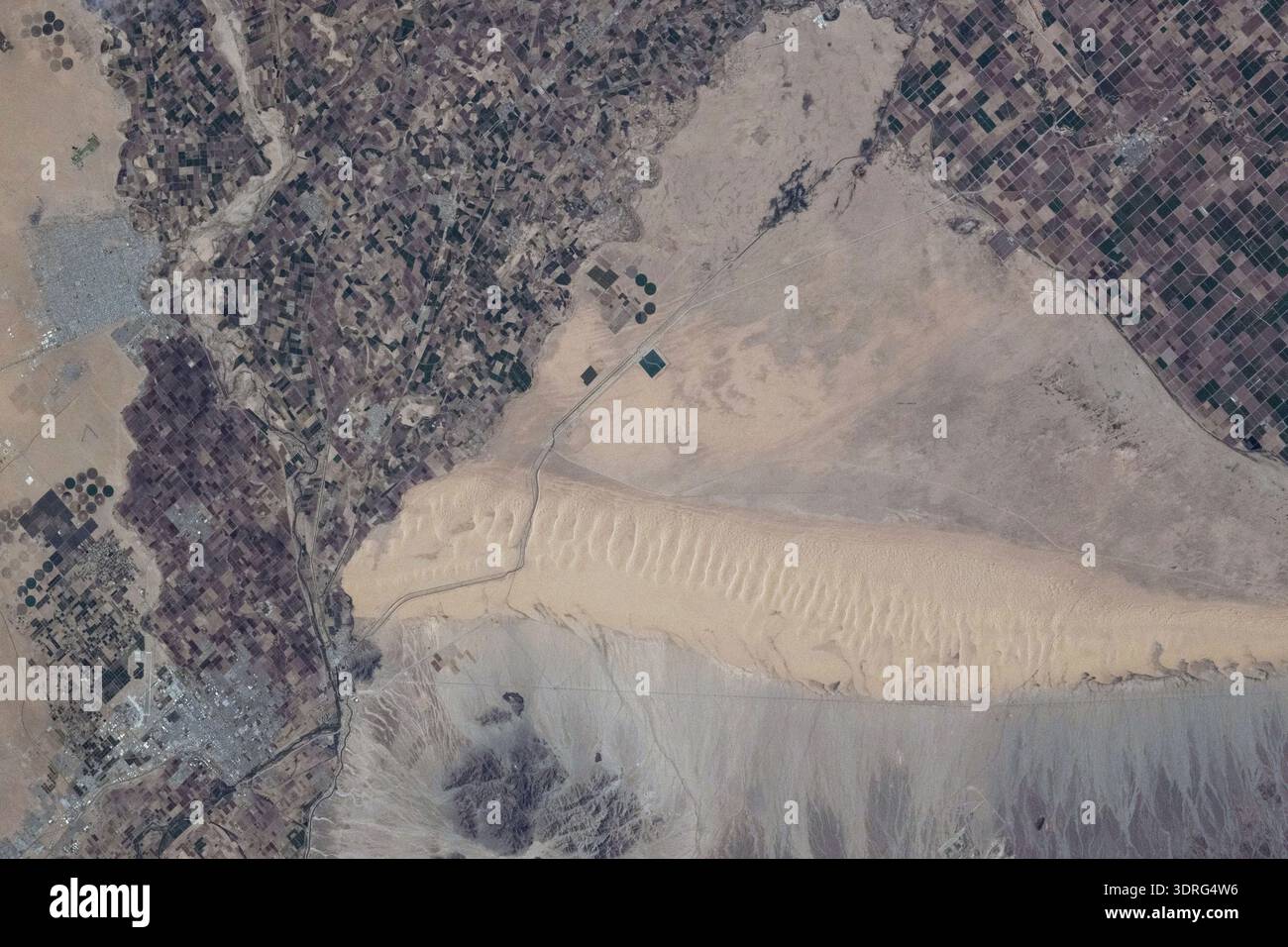 Il confine tra gli Stati del MexicoÐUnited separa la Baja California (a sinistra) sul lato messicano dalla California (a destra) sul lato statunitense in questa foto dalla stazione spaziale Internazionale mentre orbitava 261 miglia sopra. Questa regione fa parte del deserto di Sonora, con le dune di Algodones ben visibili sul lato statunitense. In alto a sinistra, si trova la città messicana di San Luis R'o Colorado con una popolazione di circa 177.000. Una fotografia scattata dalla stazione spaziale Internazionale il 1° ottobre 2025 una versione ottimizzata di un'immagine originale della NASA: Credit NASAinhospitable Foto Stock