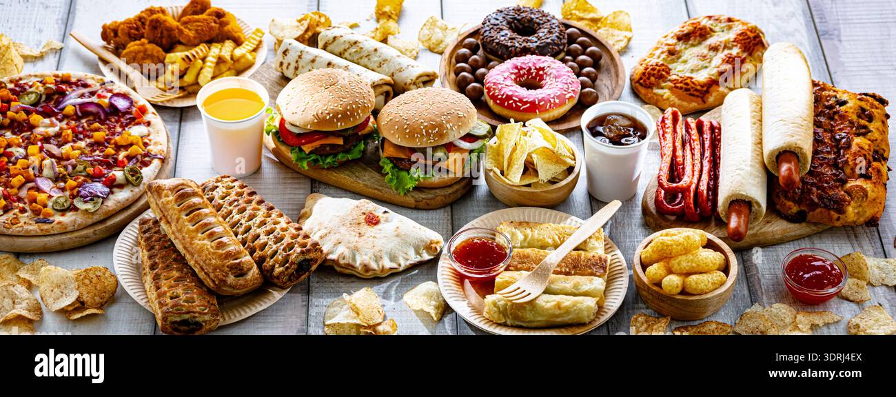Alimenti che aumentano il rischio di cancro. Cibo spazzatura Foto Stock