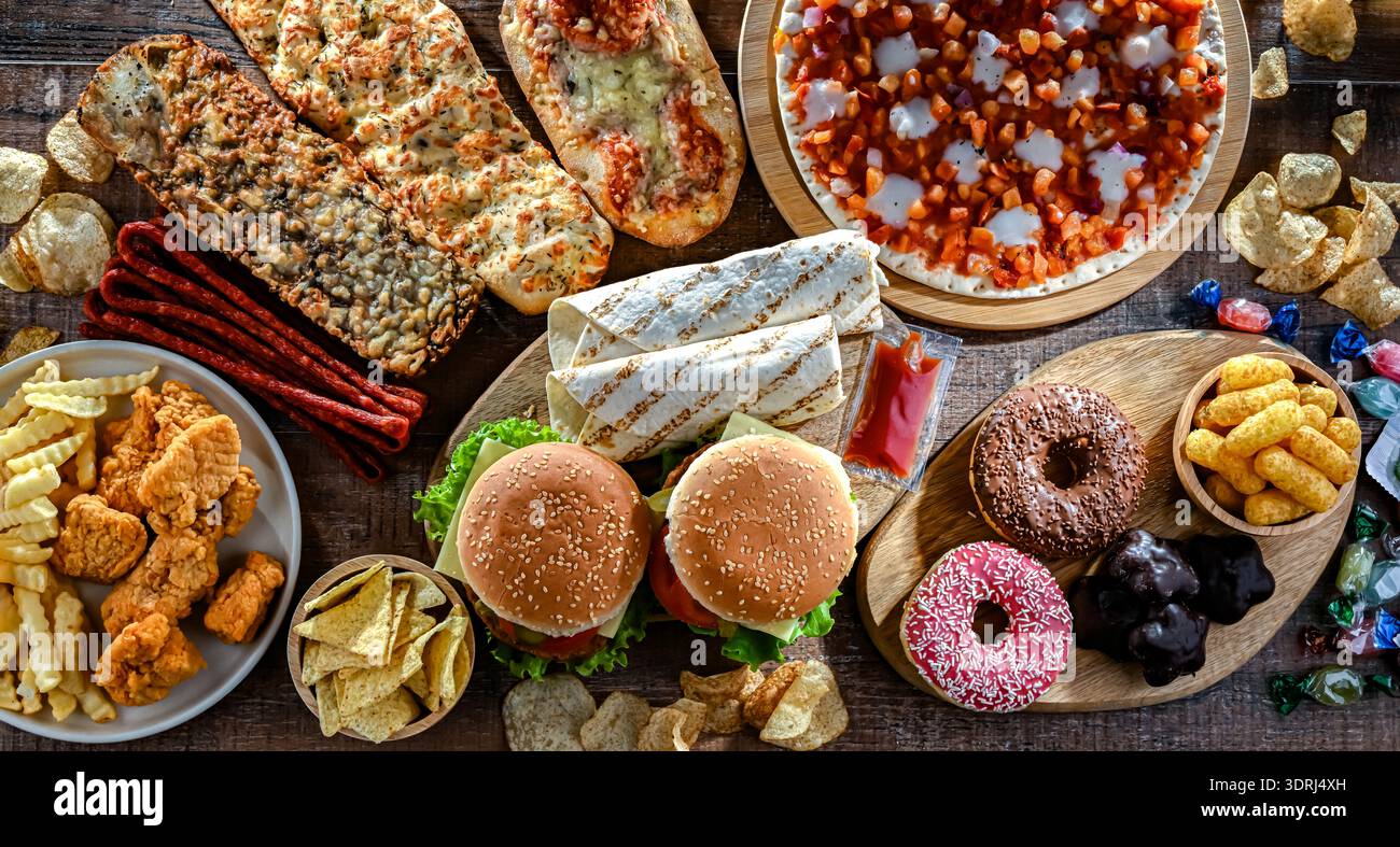 Alimenti che aumentano il rischio di cancro. Cibo spazzatura. Foto Stock