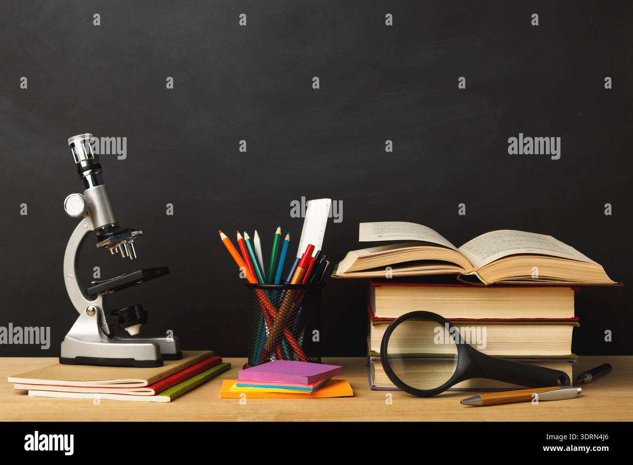 Raccolta di forniture scolastiche e strumenti scientifici su una scrivania per attività di studio e apprendimento Foto Stock