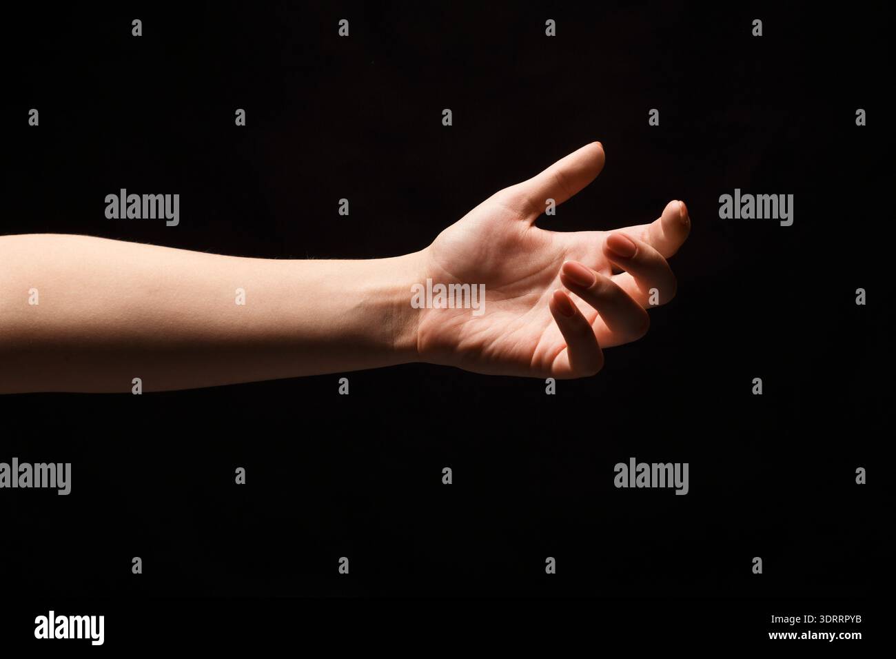 Mano che raggiunge uno spazio buio creando una connessione visiva all'interno di un collage mosaico Foto Stock