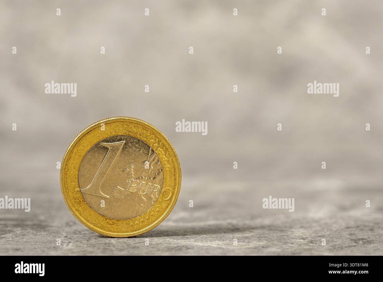Una moneta in euro con la mappa dell'Europa. Moneta da 1 euro su fondo in pietra con spazio per copia Foto Stock