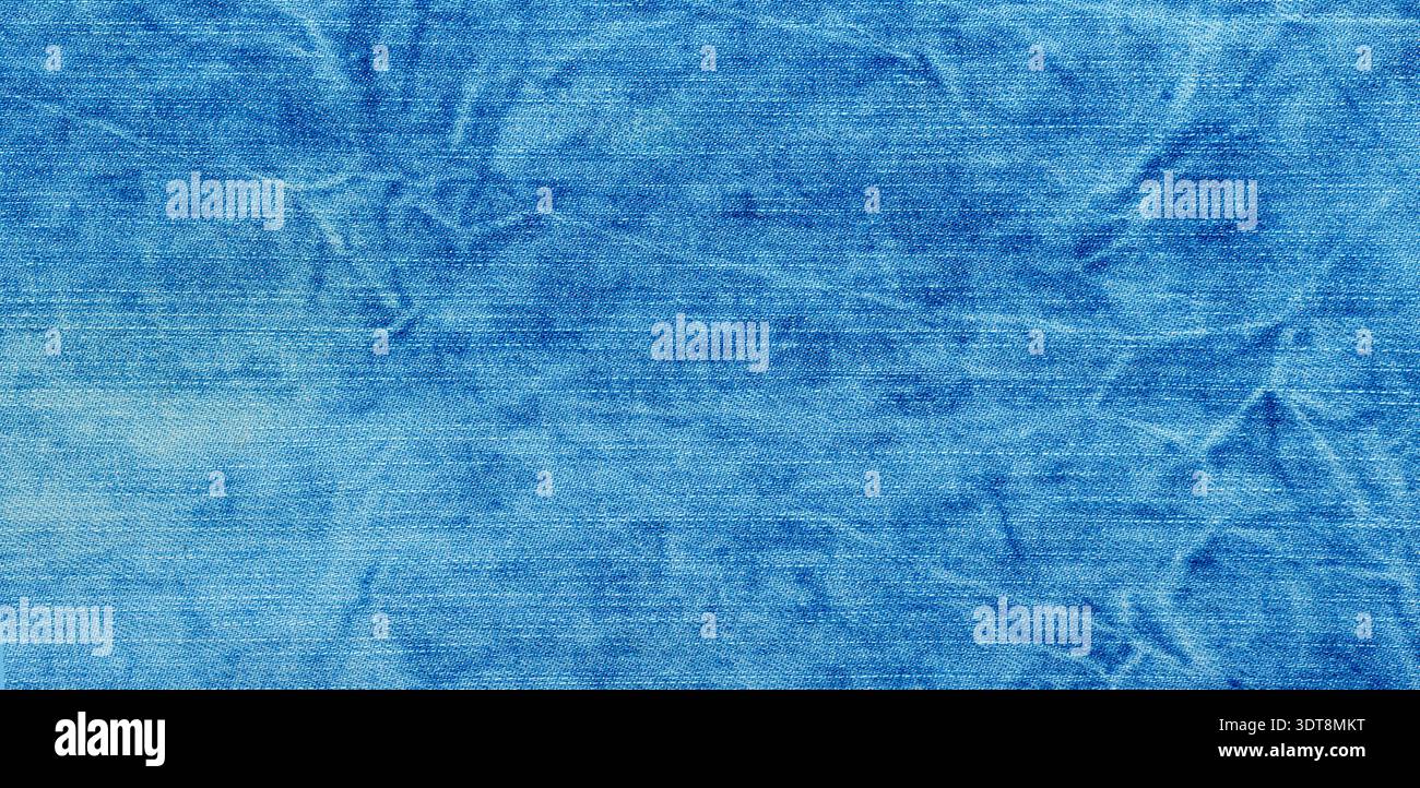 Tessuto denim blu con grinze che mostra una superficie in tessuto sbiadita e usurata Foto Stock