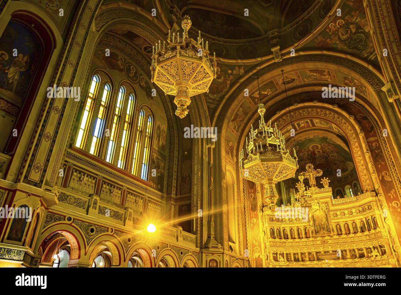 Vista dal mantice dei lampadari dorati appesi sul soffitto, all'interno della vecchia cattedrale ortodossa di Timisoara, Romania Foto Stock