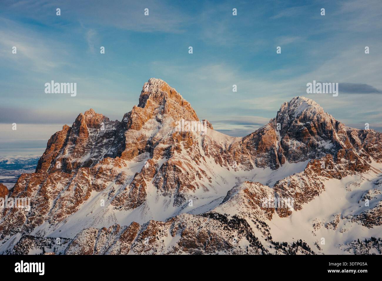Vette alpine innevate che brillano nella calda luce della sera. Foto Stock