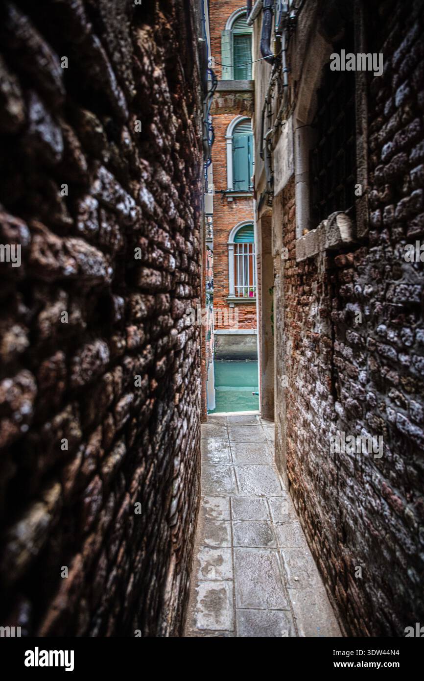 Uno stretto vicolo di Venezia offre uno scorcio dell'architettura storica della città. Foto Stock