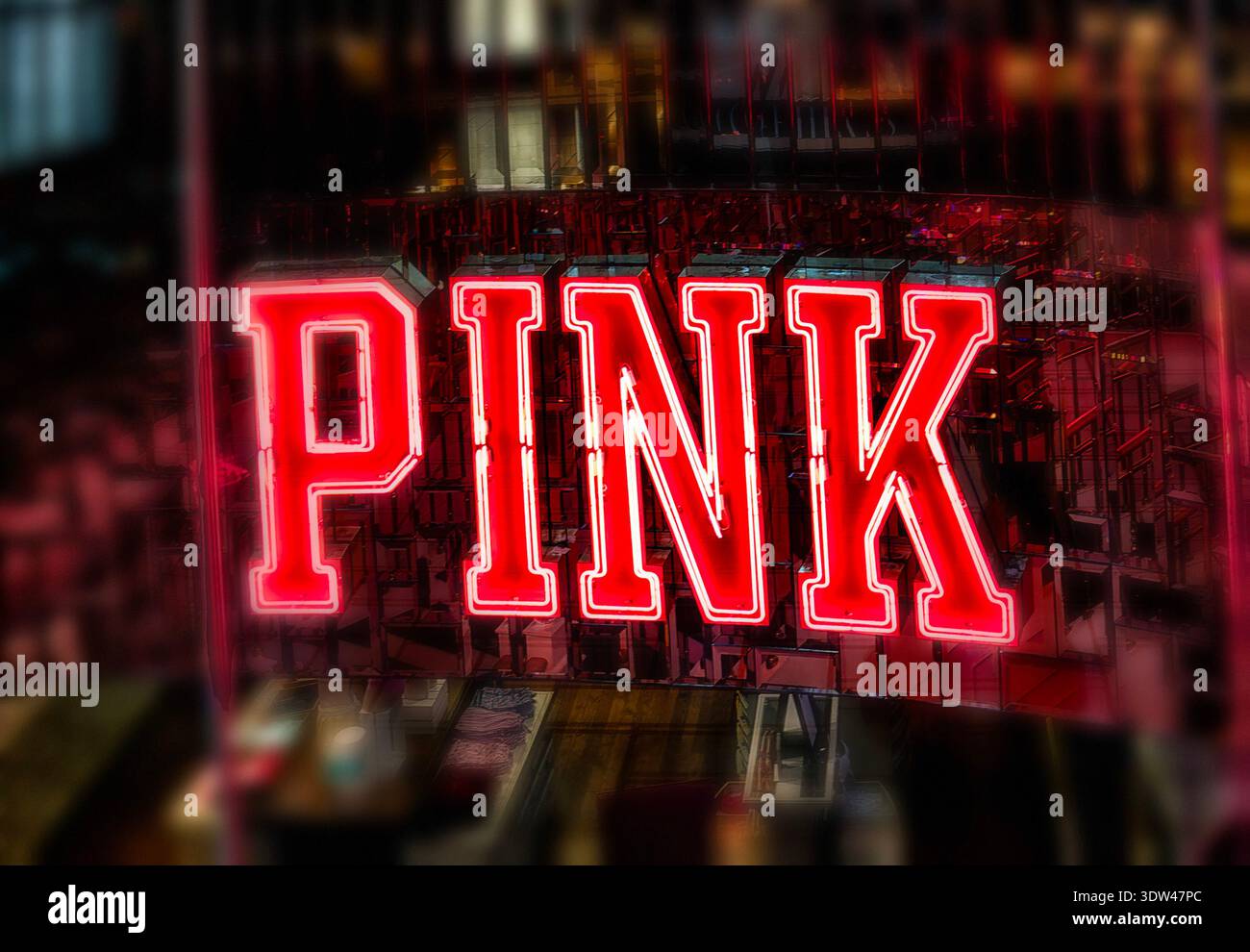 Un'insegna al neon rosa brillante Foto Stock