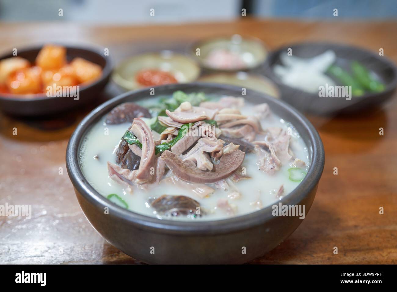 Autentico Sundaeguk coreano (zuppa di salsiccia di sangue) con pancetta di maiale, intestini e contorno di gamberi salati in un ristorante tradizionale locale a Geoje. Foto Stock
