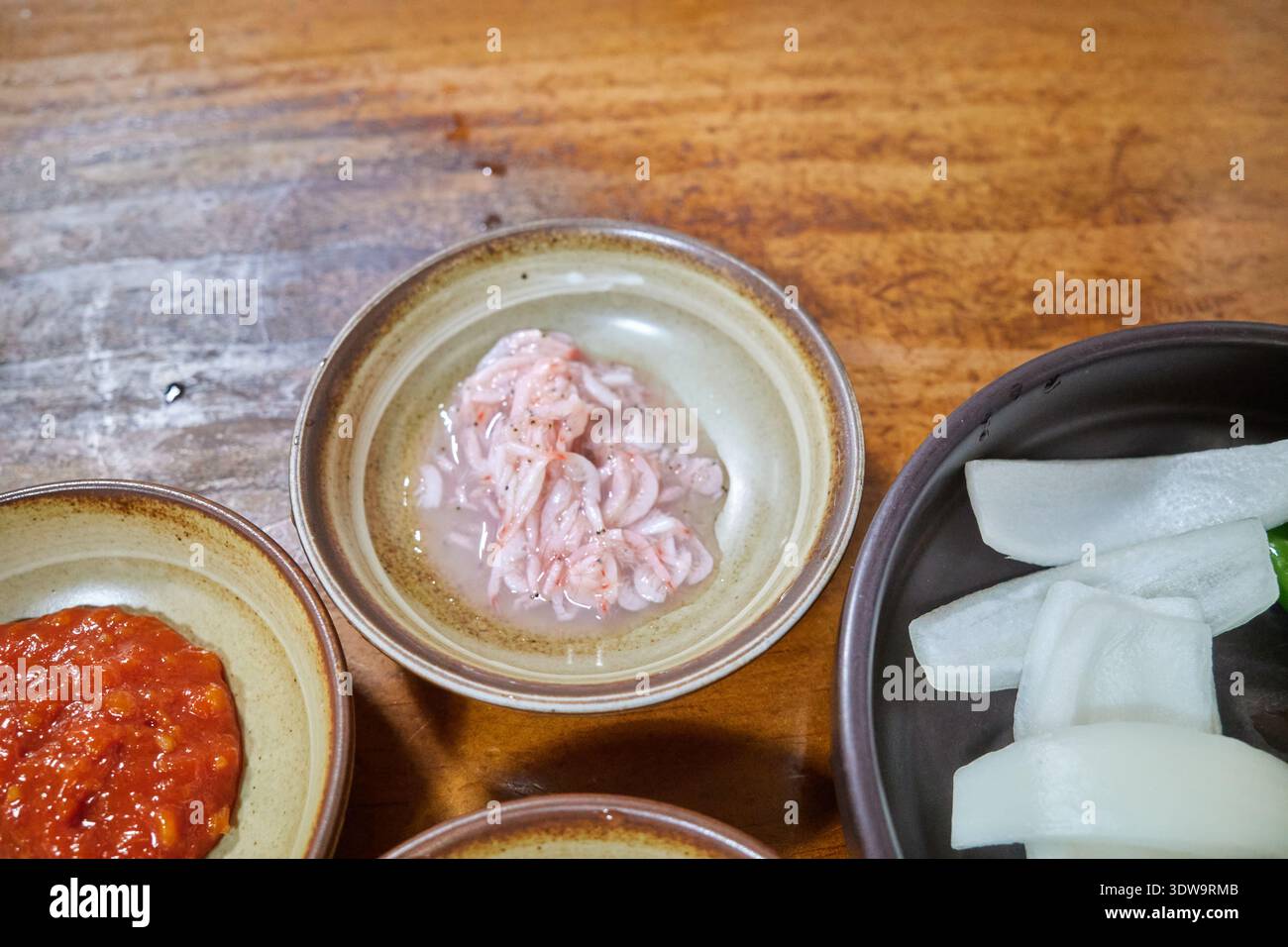 Autentico Sundaeguk coreano (zuppa di salsiccia di sangue) con pancetta di maiale, intestini e contorno di gamberi salati in un ristorante tradizionale locale a Geoje. Foto Stock