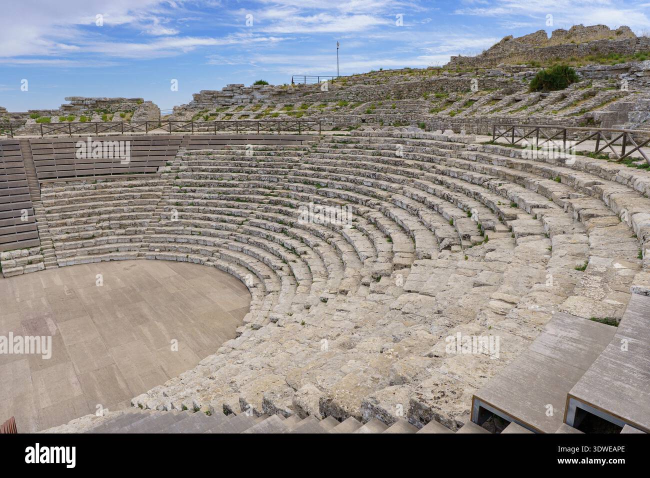 Un'avvincente e ampia vista del Teatro Greco di Segesta, che mostra la cavea in pietra semicircolare (posti a sedere) in ottima conservazione. L'i Foto Stock