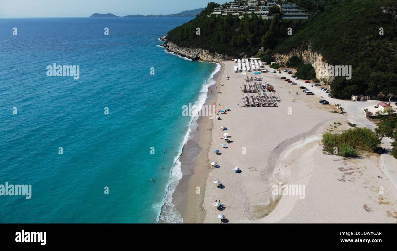 Ampia vista aerea della spiaggia di Karavostasi vicino a Perdika, Grecia. Colpo di droni della lunga costa sabbiosa, del mare turchese dello Ionio e delle lussureggianti colline verdi in estate. Foto Stock