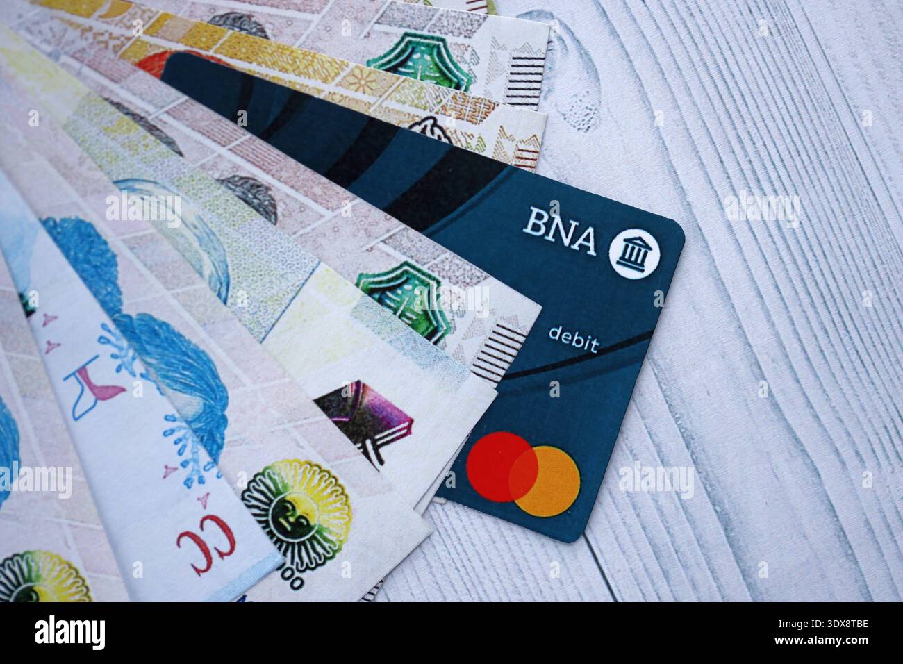 KIEV, UCRAINA - 28 GENNAIO 2026 carta Banco de la Nacion Argentina e banconote in valuta argentina sul tavolo da vicino. Il Banco de la Nacion Argentina è la banca più popolare in Argentina Foto Stock