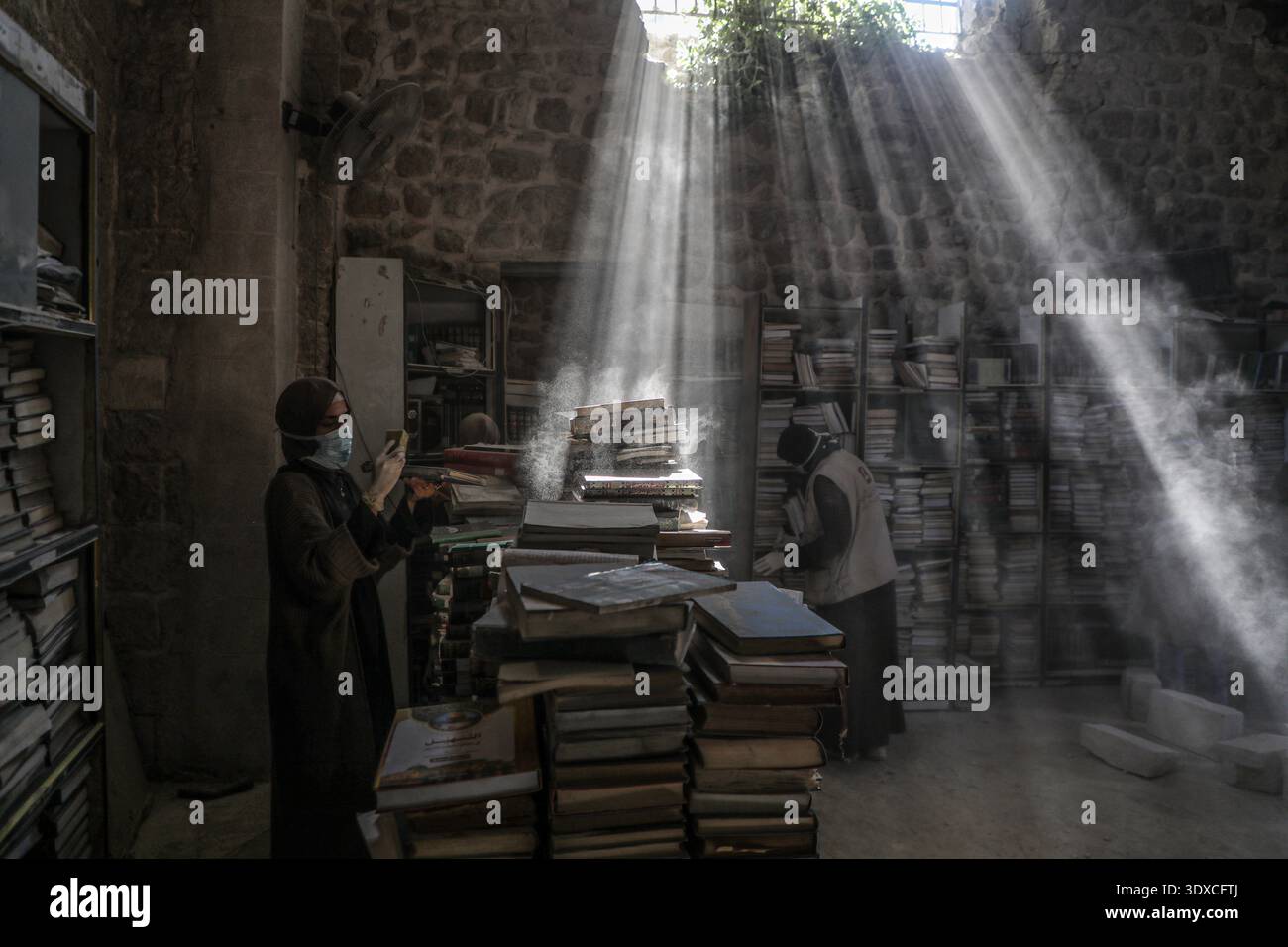 La città di Gaza, la grande Moschea Omari nella città vecchia di Gaza. 2 marzo 2026. Volontari palestinesi libri di polvere come parte degli sforzi iniziali di salvataggio e restauro per libri e manoscritti distrutti durante il bombardamento israeliano della Striscia di Gaza, all'interno della biblioteca della grande Moschea Omari nella città Vecchia di Gaza, il 2 marzo 2026. Crediti: Rizek Abdeljawad/Xinhua/Alamy Live News Foto Stock