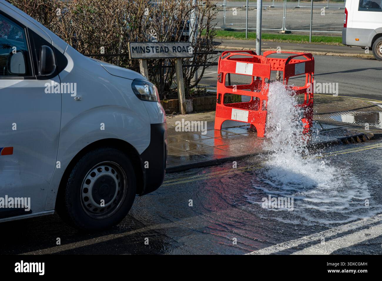 Il canale principale e il tubo di scarico dell'acqua inondano la strada in una strada a Portsmouth, Hampshire, Regno Unito Foto Stock