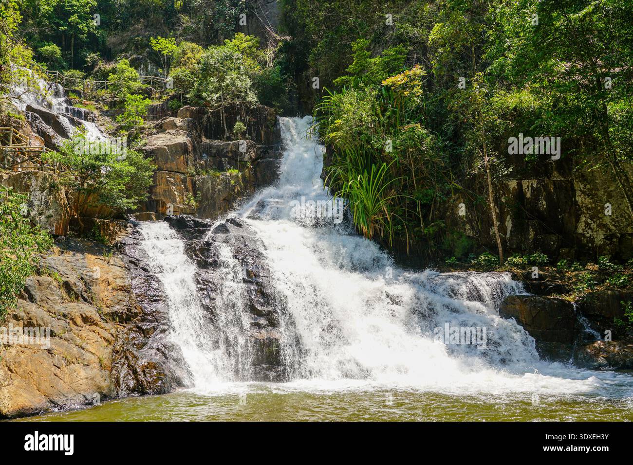 Flusso multilivello della cascata Datanla che si estende attraverso le lussureggianti rocce della giungla a da Lat, Vietnam Foto Stock