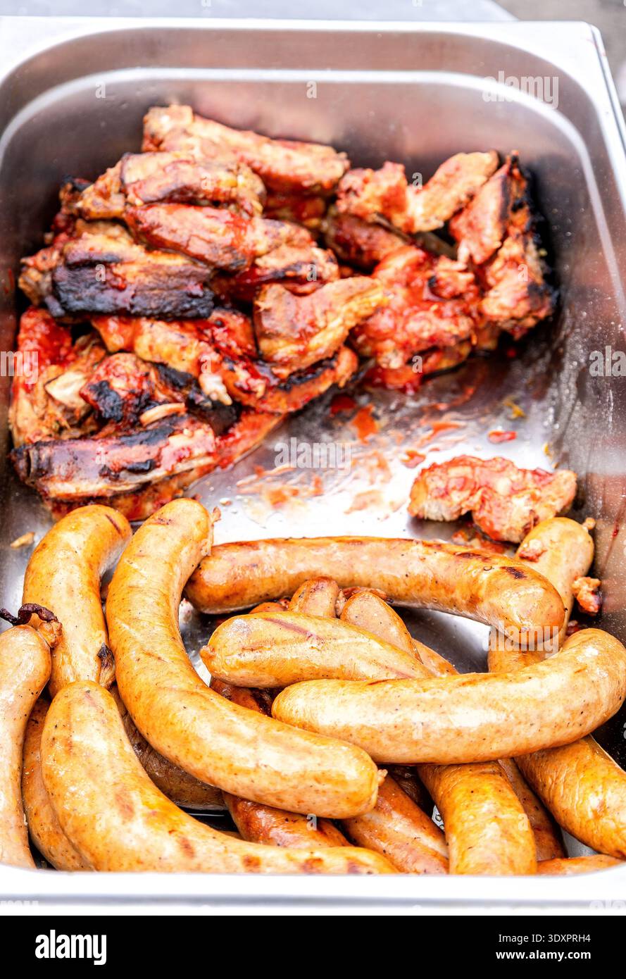 Appetitose carni al forno e salsicce barbecue all'aperto. Cibo di strada Foto Stock