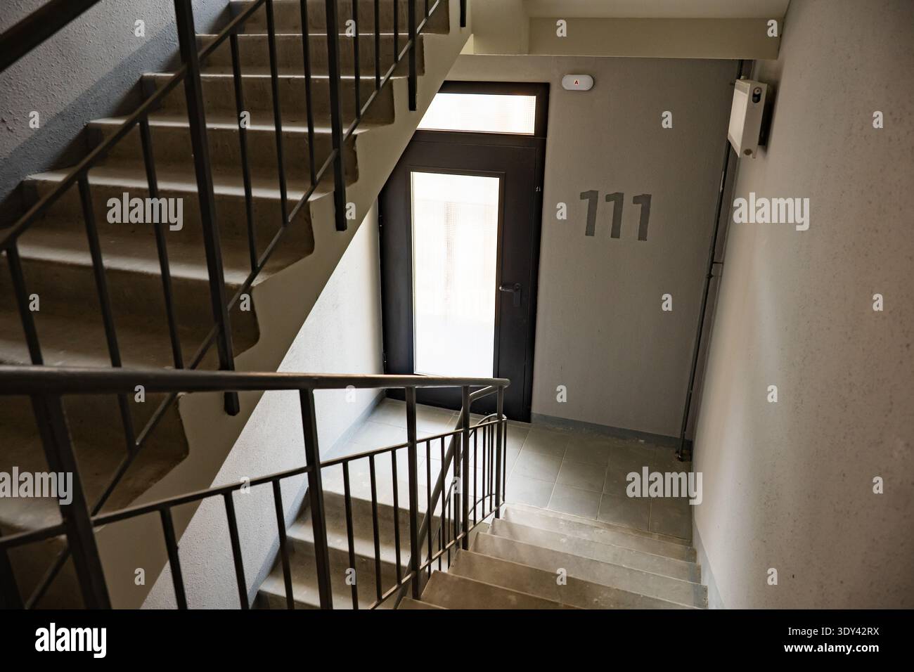 Scala in un edificio moderno con il numero 111 accanto ad una porta Foto Stock