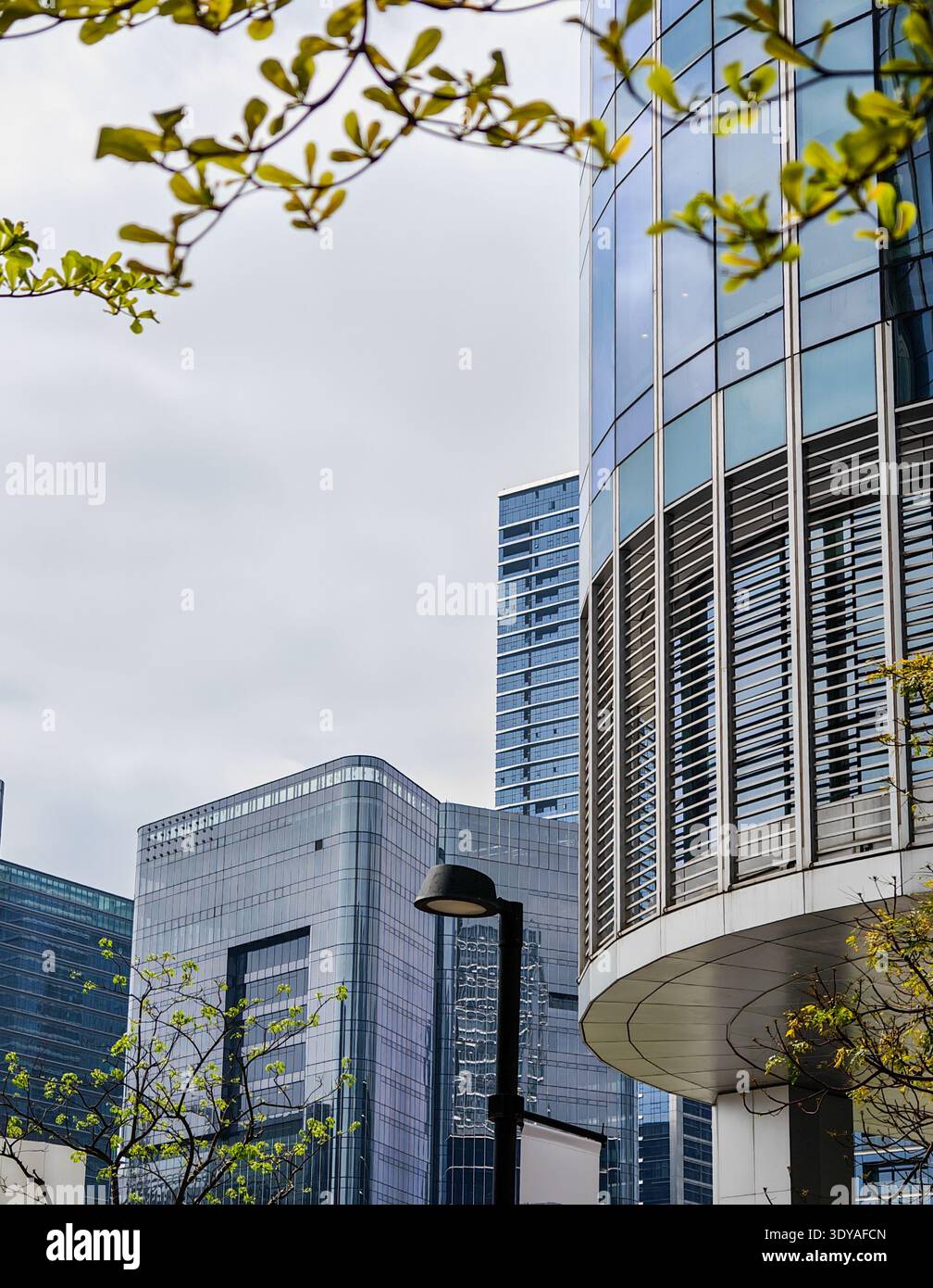 Una fotografia ravvicinata ad alto angolo che mostra un edificio suggestivo e curvo con spranghe orizzontali in un cielo coperto in Cina. Foto Stock