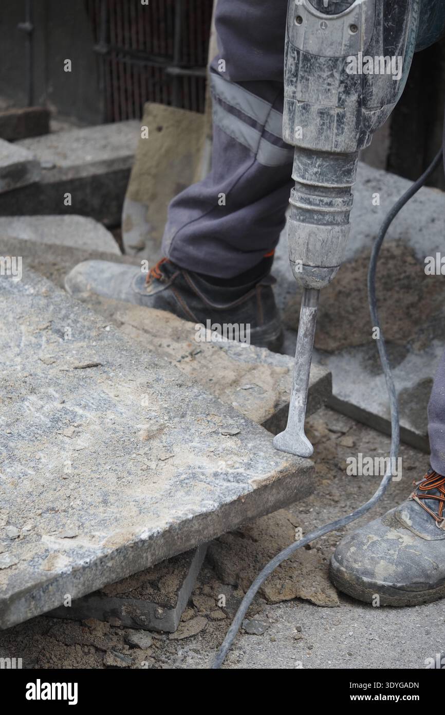 Lavoratore che utilizza l'utensile nel cantiere per lavori in pietra Foto Stock