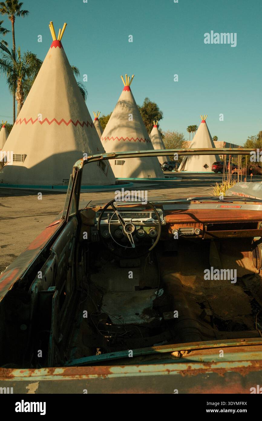 Classica cabriolet parcheggiata accanto alle cabine teepee al Wigwam Motel di San Bernardino, California, USA. Foto Stock