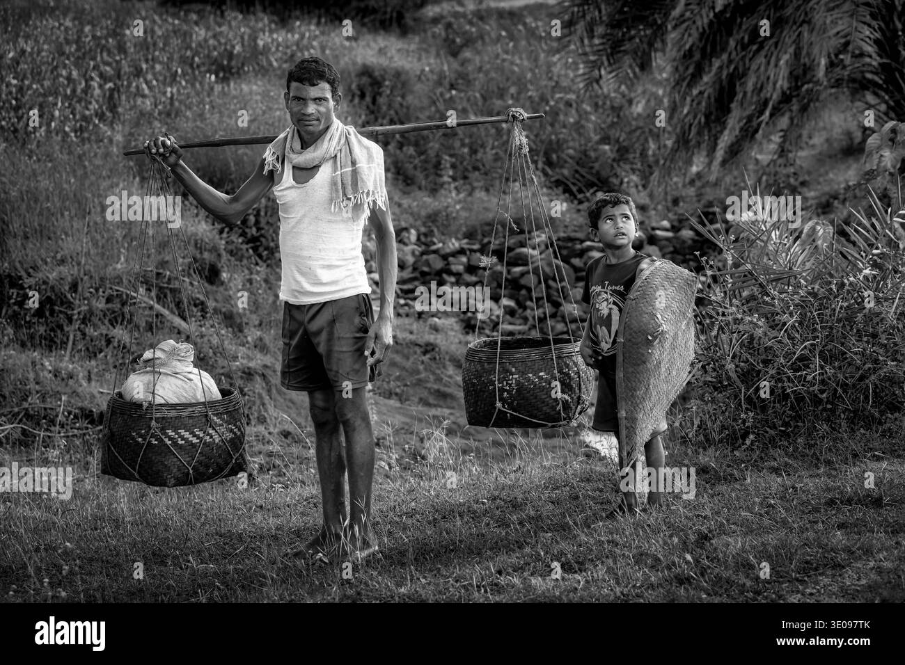 Padre e figlio sulla via del ritorno dopo una giornata nei campi di accoglienza, Orissa, India, Asia Foto Stock