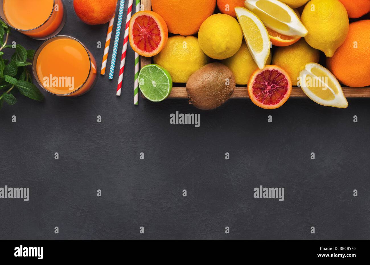 Agrumi e bicchiere di succo fresco Foto Stock